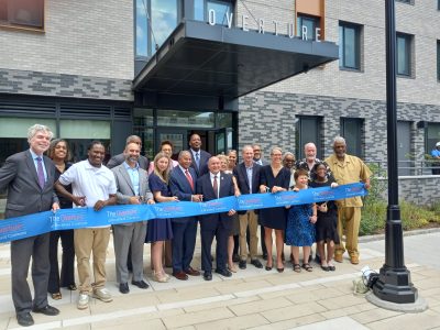 Officials and dignitaries get ready to cut the ribbon outside the front entrance of The Overture at Brookfield, a new affordable housing project that recently opened in White Plains. 